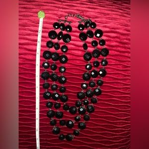 Triple strand black beaded necklace.